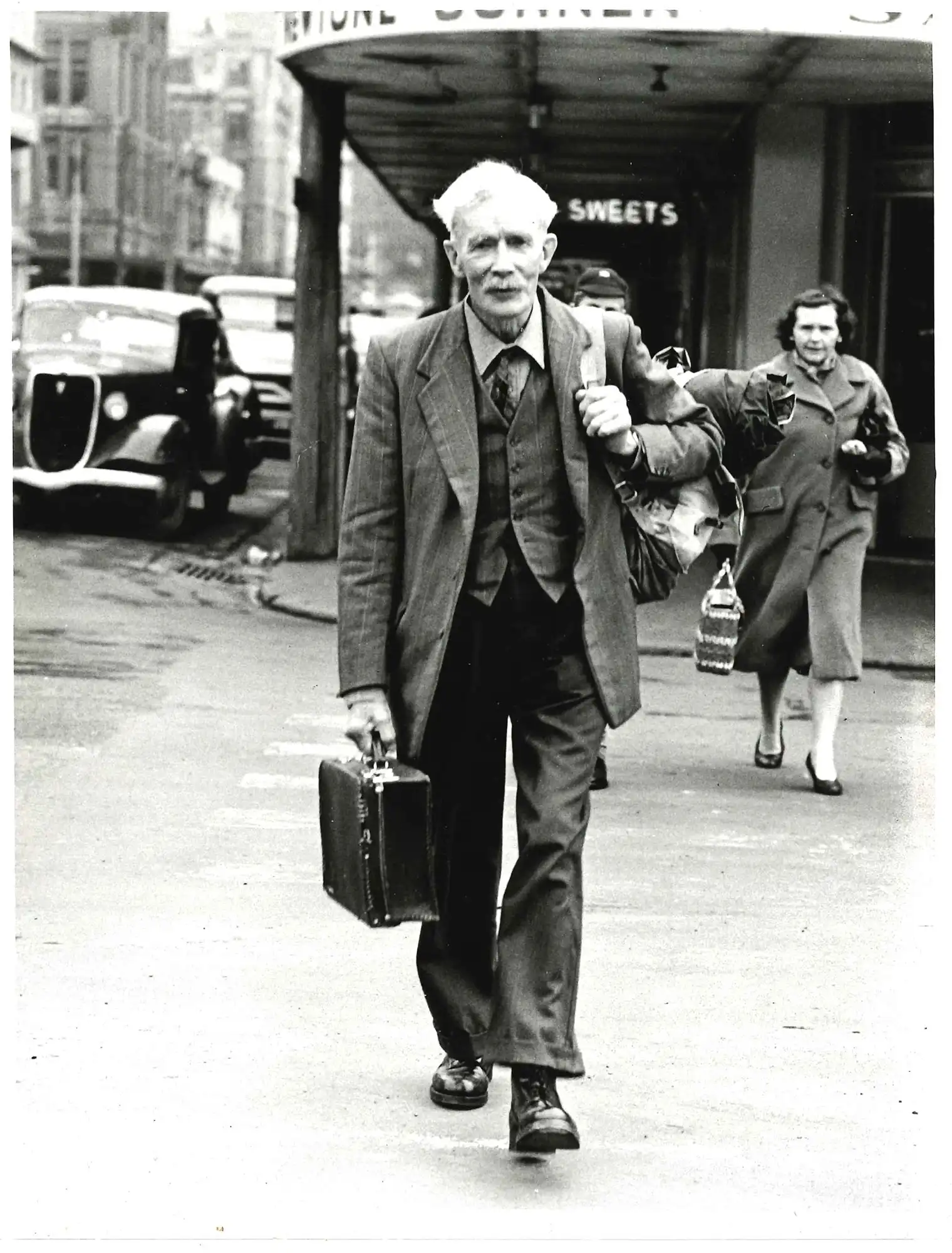 Photograph of A.H. Reed in town with suitcase, From North Cape to Bluff walk (Evening Star)