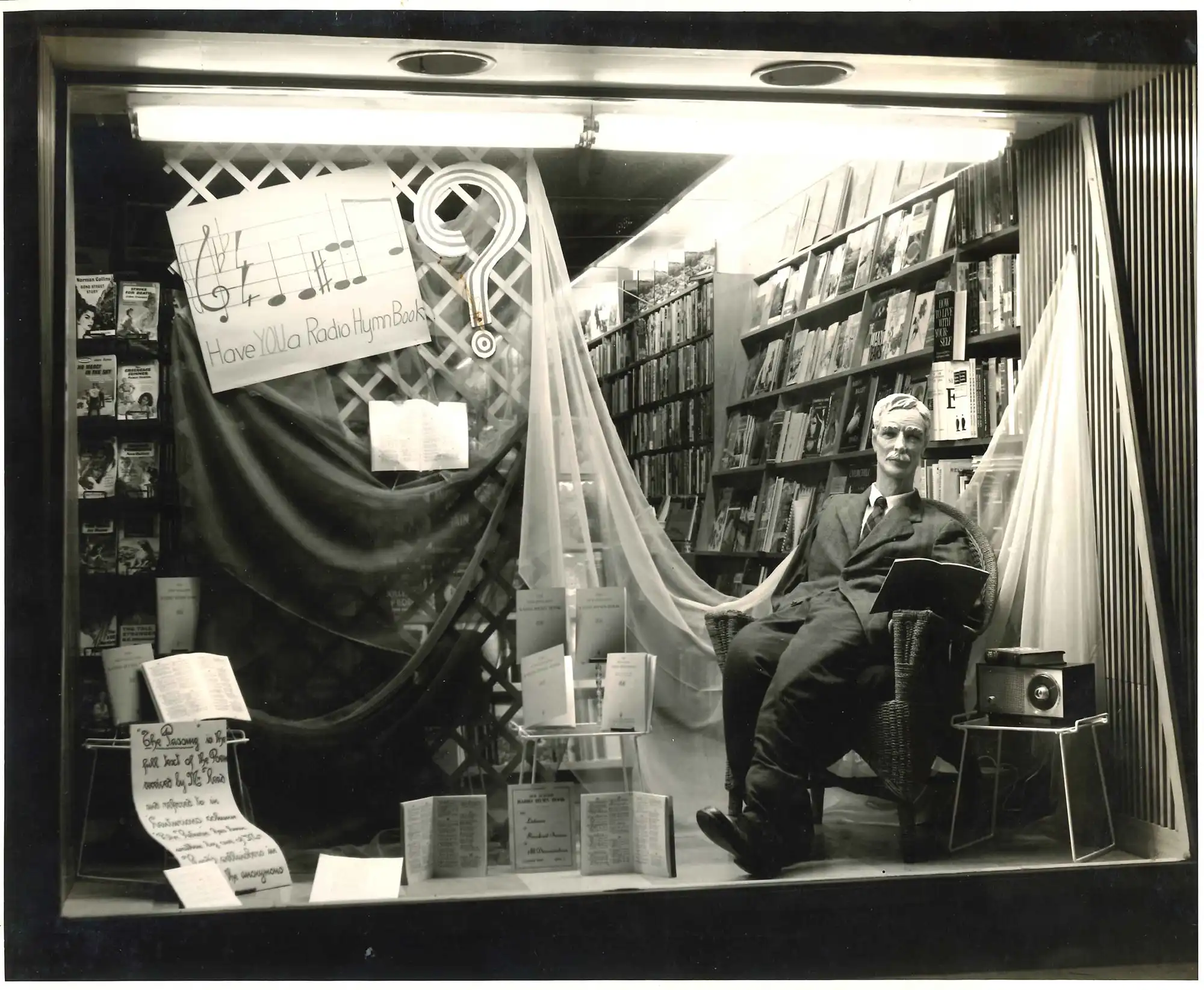 Photograph of dummy of A.H. Reed displayed in window of Presbyterian Bookroom, Octagon, Dunedin as a promotional display for From North Cape to Bluff, ca. 1961. Photograph by Hurst and Palmer Ltd, George Street.