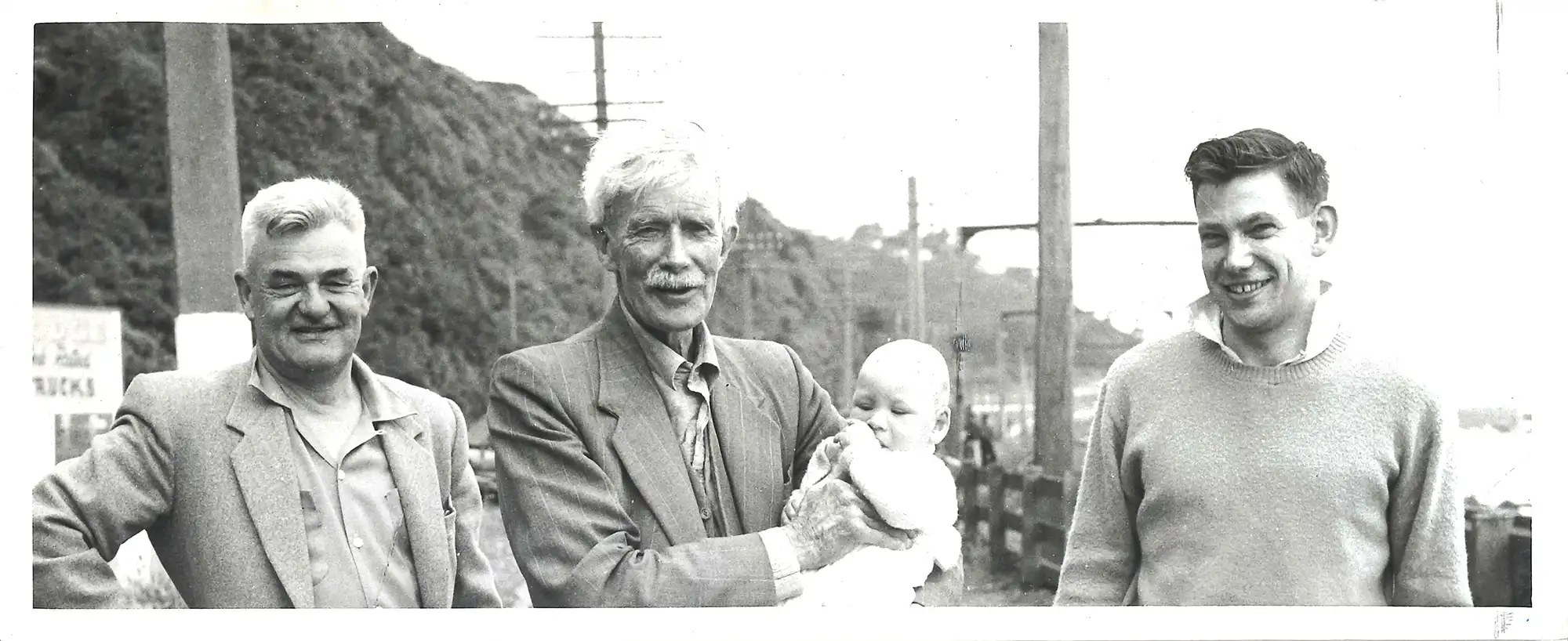 Photograph of A.W., A.H. and John Reed with young Donald Reed, 1960 (NZ Newspapers Ltd.)